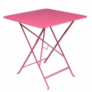 Pink square bistro table with folding metal frame. Outdoor dining furniture.