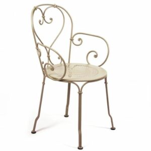 Elegant metal armchair with curved design. Vintage-style furniture. Patio chair. Outdoor seating. Cream-colored chair.