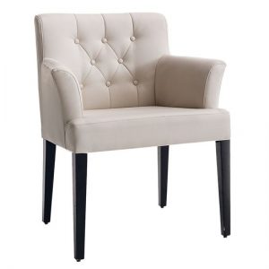 Upholstered armchair in cream with button tufting and dark wood legs. Modern accent chair.