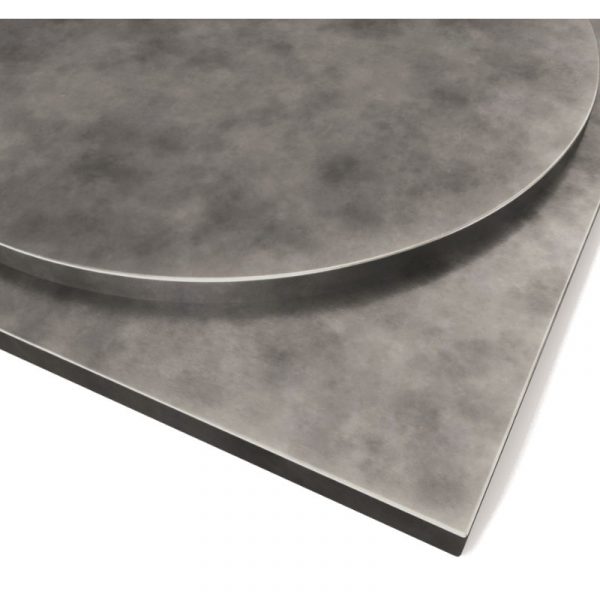 Close-up of a round and square METAL ZINC PATINA TABLE TOP, showing the grey, textured surface and edge detail.