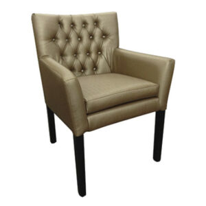 Angled view of a Nix Armchair. Features a tan, fully upholstered seat and back with button detailing, and a black beech frame.