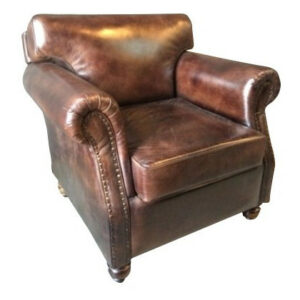 Vintage brown faux leather Nevada Armchair. Upholstered lounge chair with wood frame, nailhead trim, and rolled arms.