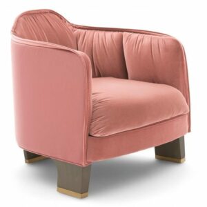 Angled view of the Edgar lounge chair in pink upholstery with a wood frame.