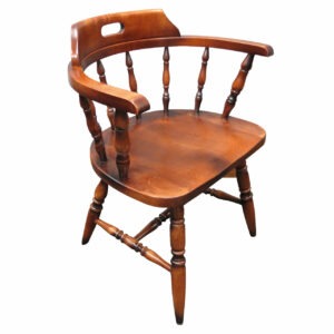 Angled view of a stained solid wood Captain Armchair with curved back and armrests.