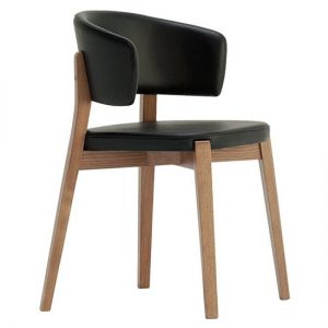 Side view of the Dixie armchair. It features a light wood frame and black upholstered seat and back.