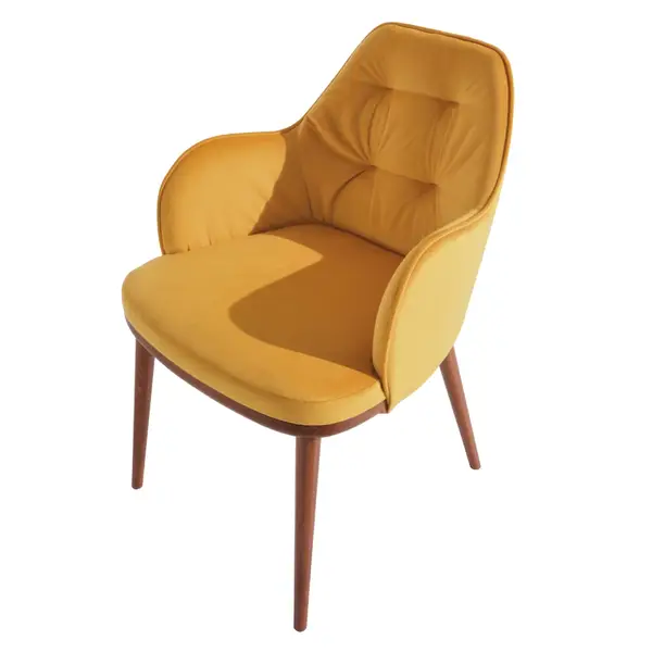 Studio shot of a Rise Armchair in yellow velvet with a button-tufted backrest and elegant tapered wooden legs.