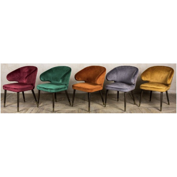 Five Curb armchairs in red, green, orange, grey, and gold faux suede fabrics. Dark walnut wooden frame with brass leg detail.