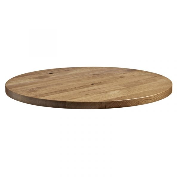 Eye-level view of a round, wood rustic antique oak table top.