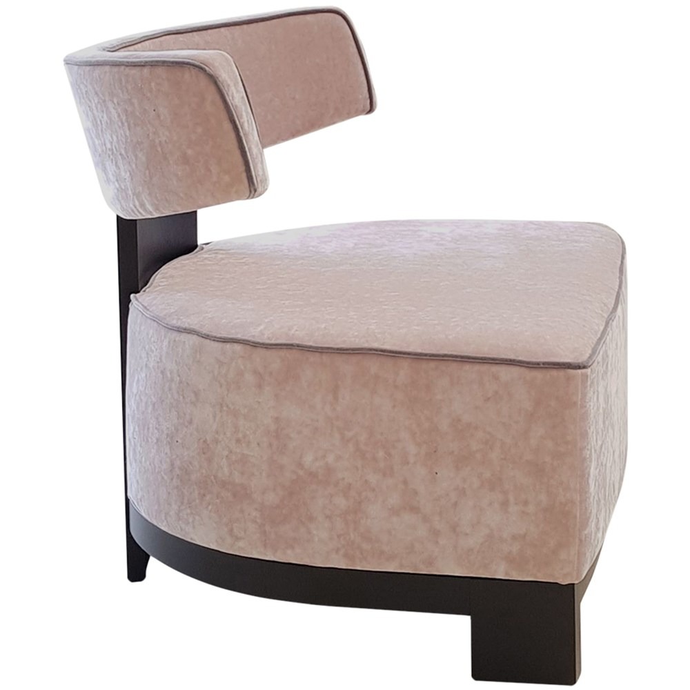 Side view of the Montreal 3 lounge chair. Upholstered in pink fabric with a dark wood frame.