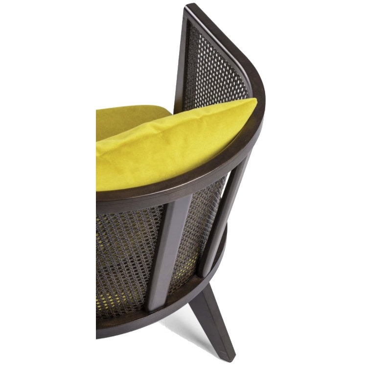 Close-up of the Roberto lounge chair, featuring a cane weave back, dark wood frame, and a yellow upholstered cushion.