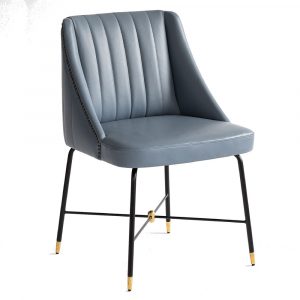 Upholstered Soho armchair in blue with a metal frame. The seat and back are vertically stitched. The legs are black with gold accents.
