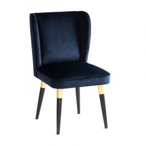Front view of a Yasmin B chair in navy velvet with wood legs and brass detailing.