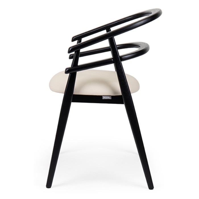 Side view of a Hullahoop armchair. Black wood frame with a cream upholstered seat.