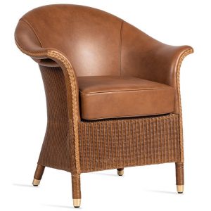 Front view of a brown leather Victor XL lazy deluxe armchair. The chair has a rattan frame, loom weave detail, and brass ferrules on its legs.