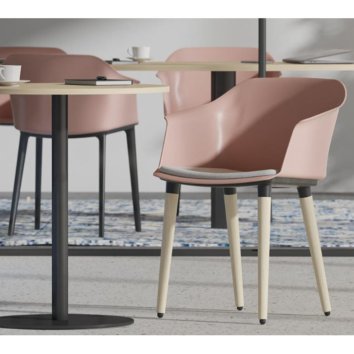 Dusty rose Polytone C Armchair with ash wood legs and optional gray upholstered seat pad. Modern design.