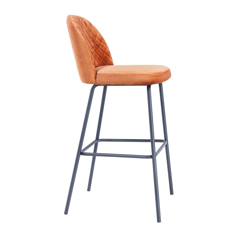 Side view of the Joy barstool. It has a black metal frame and an orange upholstered seat and back with a quilted pattern.