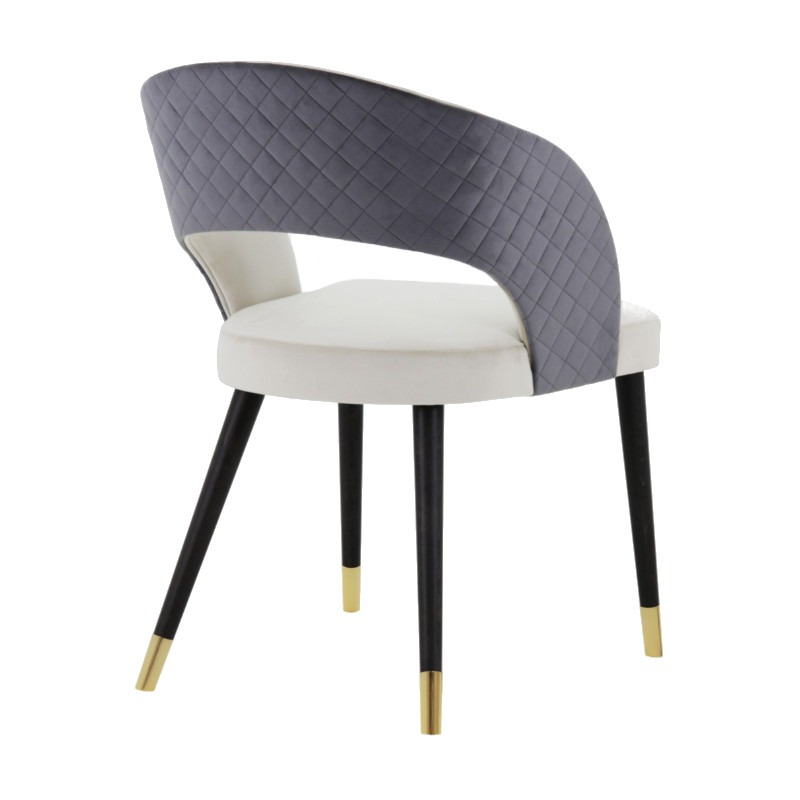Rear view of Giulia side chair. Upholstered in gray quilted fabric on the back and white on the seat. Black wooden legs with gold tips.