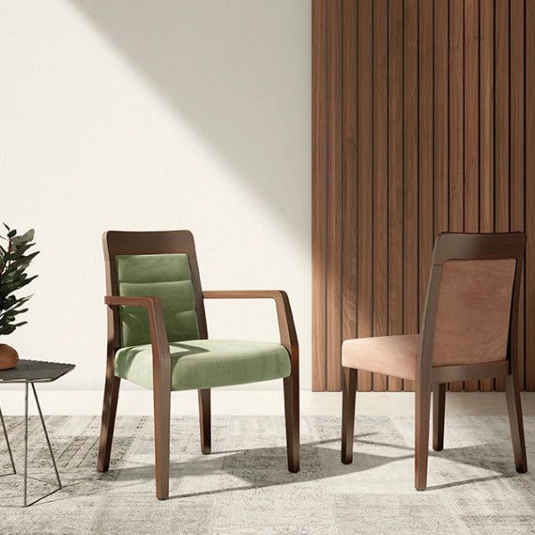 Two Dora Side Chairs featuring dark wooden frames, one with sage green tufted upholstery and one with soft pink fabric.