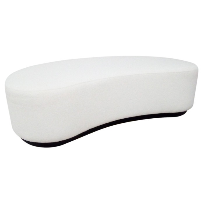 Angled view of the white upholstered Stanton Pouf with a beech wood frame.