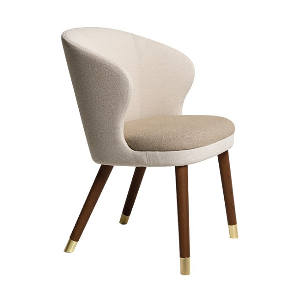 Upholstered Heritage armchair. Cream back and seat, brown wooden legs with gold caps.