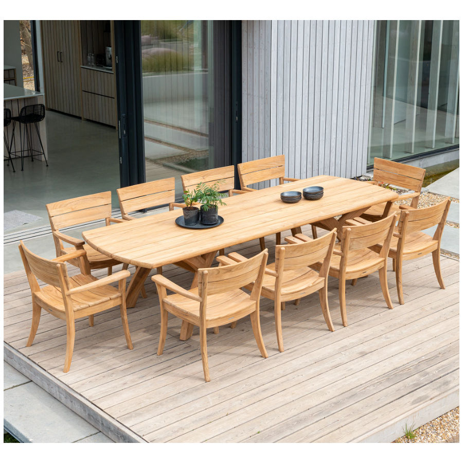 Outdoor dining set with a Sorrento Armchair at each end of a long wooden table. The chairs and table are light brown wood.