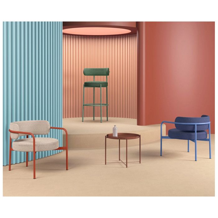 Group of two Giotto armchairs in beige and blue with metal frames displayed in a colorful, modern architectural studio.