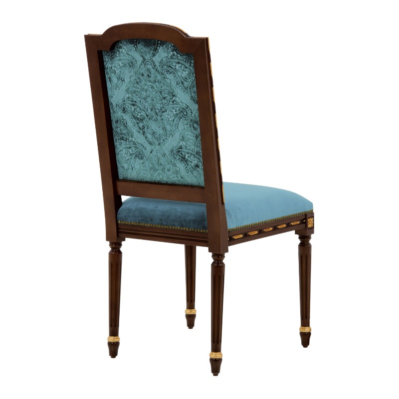 Rear view of a Ginevra side chair. Wood frame, blue upholstered seat, and paisley patterned back.