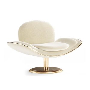 Side view of the Eddie armchair. Cream upholstery with polished brass frame and wooden plinth.