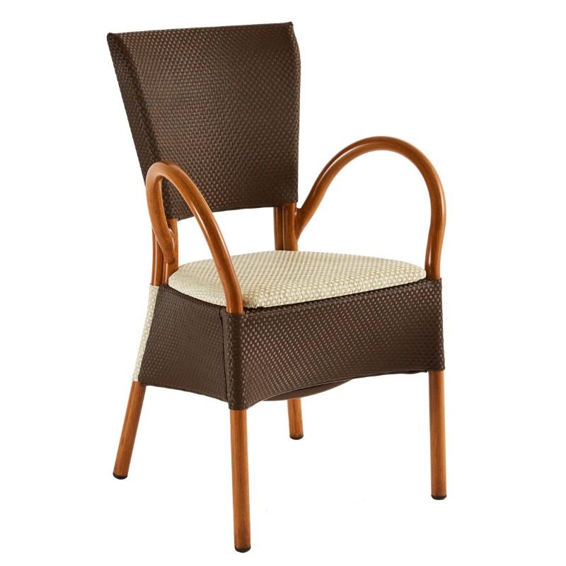 Front view of the stackable Mister Armchair. It has a brown woven frame, light patterned seat, and curved wooden armrests.