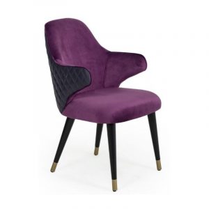 Angled view of the purple Bancor armchair. Features black, quilted back and black wooden frame with metal detailing.