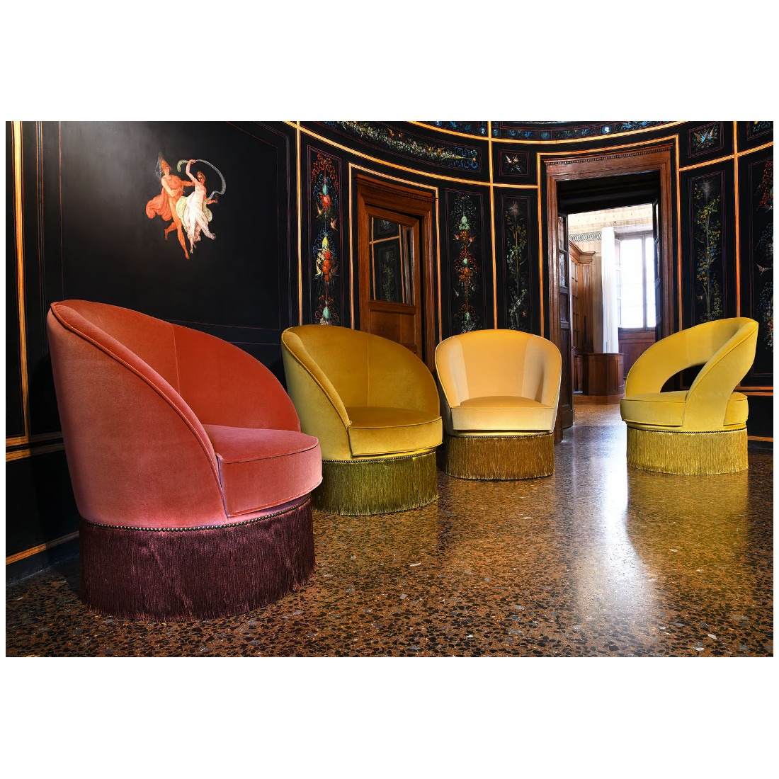 Four Dione lounge chairs in various colors with fringe detail. Upholstered seat and back.
