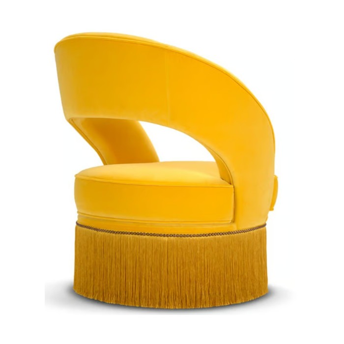 Upholstered yellow Dione Lite lounge chair with a rounded back and long fringe detail. Modern lounge furniture.
