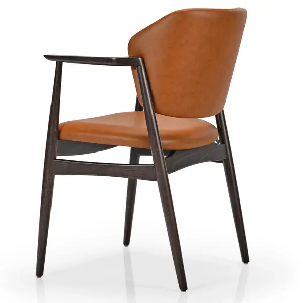 Rear view of the Silene armchair showcasing smooth cognac-colored upholstery against a dark wood 4-legged frame.