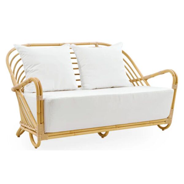 Rattan framed Charlotte Sofa with white upholstered seat and back cushions. Outdoor furniture.