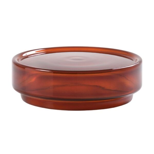 Close-up of the round, stackable Stack coffee table made of brown glass.