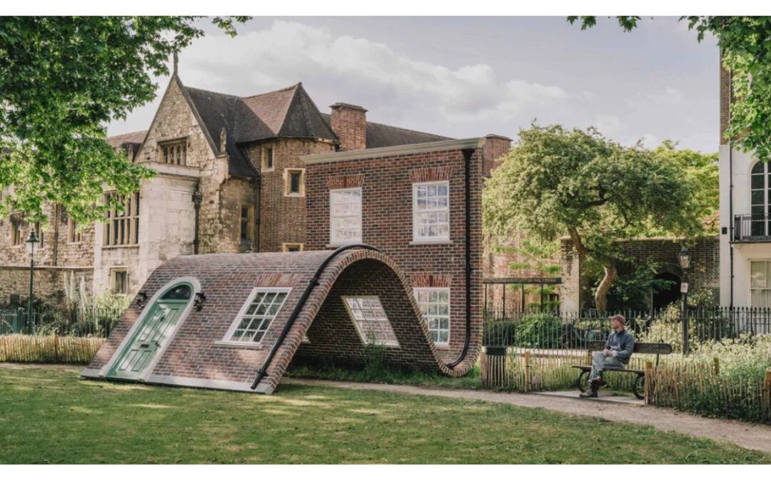 Clerkenwell Design Week 2025: Architectural art installation in a park with a man sitting on a bench.