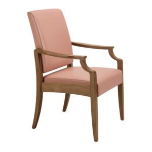 Angled view of a Janelle high back armchair. Wood frame with light pink upholstered seat and back. Traditional style.
