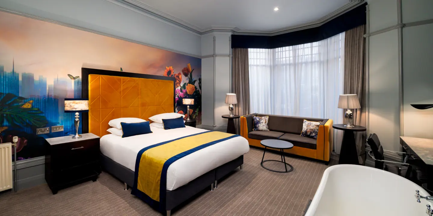 Hotel Furniture Malmaison Aberdeen, Malmaison Aberdeen Club Deluxe Room. Hotel bedroom with bed, sofa, and bathtub. Luxury hotel interior.