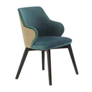 Angled view of Marie cane armchair. Teal upholstered seat and inside back with a cane outer back and dark wooden frame.