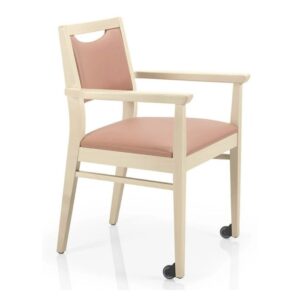 Angled view of the Bety W Armchair featuring a light wood frame and blush-colored upholstered seat and back with wheels.