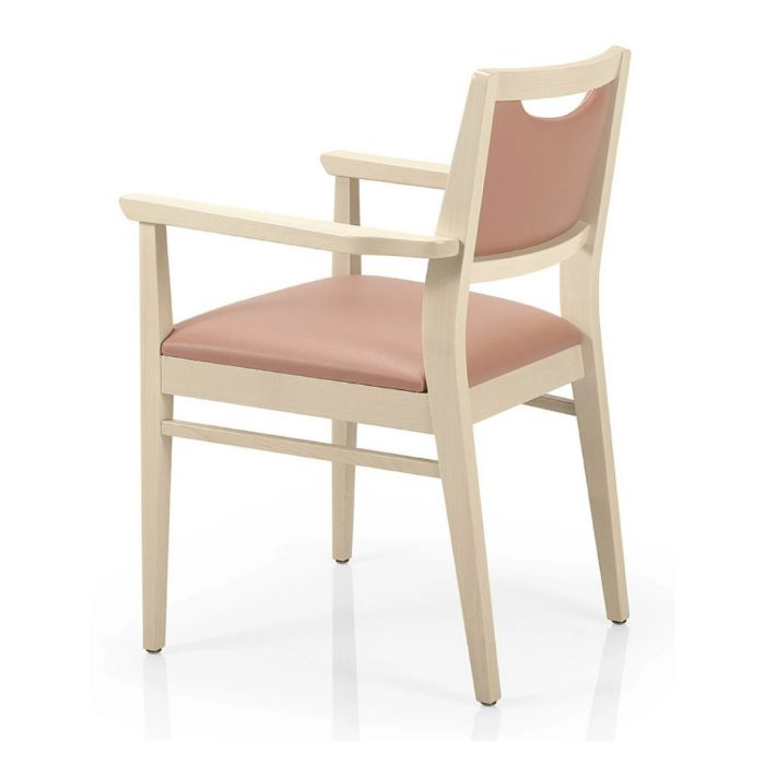 Rear view of the Bety Armchair showcasing its light wood frame and upholstered seat and back in a soft pink hue.