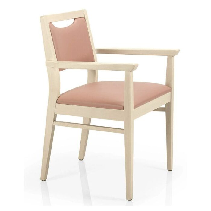 Angled view of the Bety Armchair: a wooden frame with upholstered seat and back in a light pink shade.