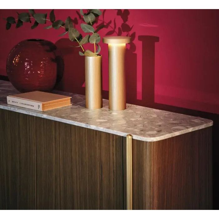 Detail shot of the Blume 4 Sideboard featuring a light stone top, dark wood doors, and decorative golden table lamps.