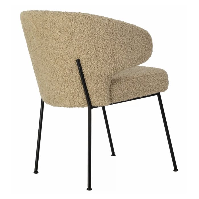 Rear view of the Ciri Armchair featuring a soft, textured, cream-colored upholstery and sleek black metal frame. Modern design.