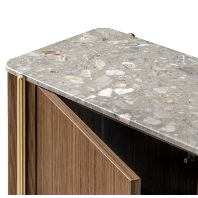 Top corner view of Blume 4 Sideboard showing a textured terrazzo surface, vertical brass leg, and open wood cabinet door.