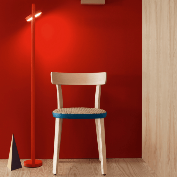 Stylish Giravolta 1799T130 floor lamp in vibrant red finish, illuminating a modern space with a chair against a red wall.