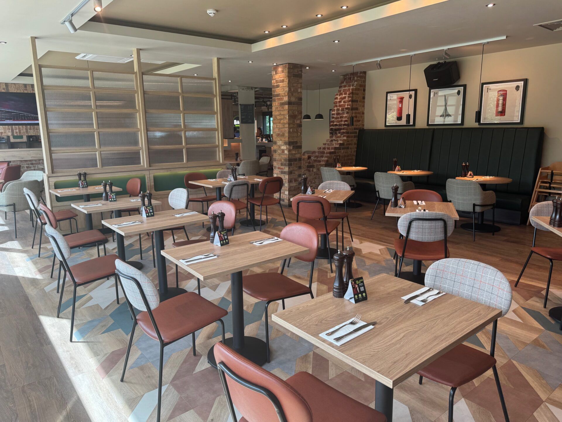 B&B Hotel Warrington B&B Hotel Warrington restaurant interior with tables, chairs, and modern design elements. Dining area.