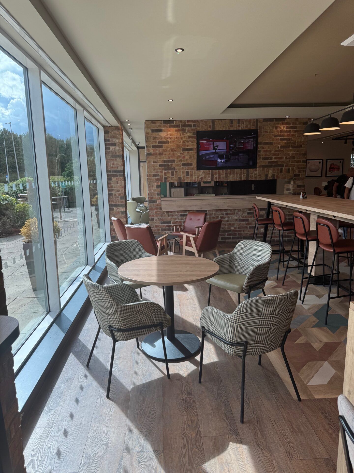 B&B Hotel Warrington B&B Hotel Warrington dining area with modern chairs and tables near large windows, creating a bright and inviting space.