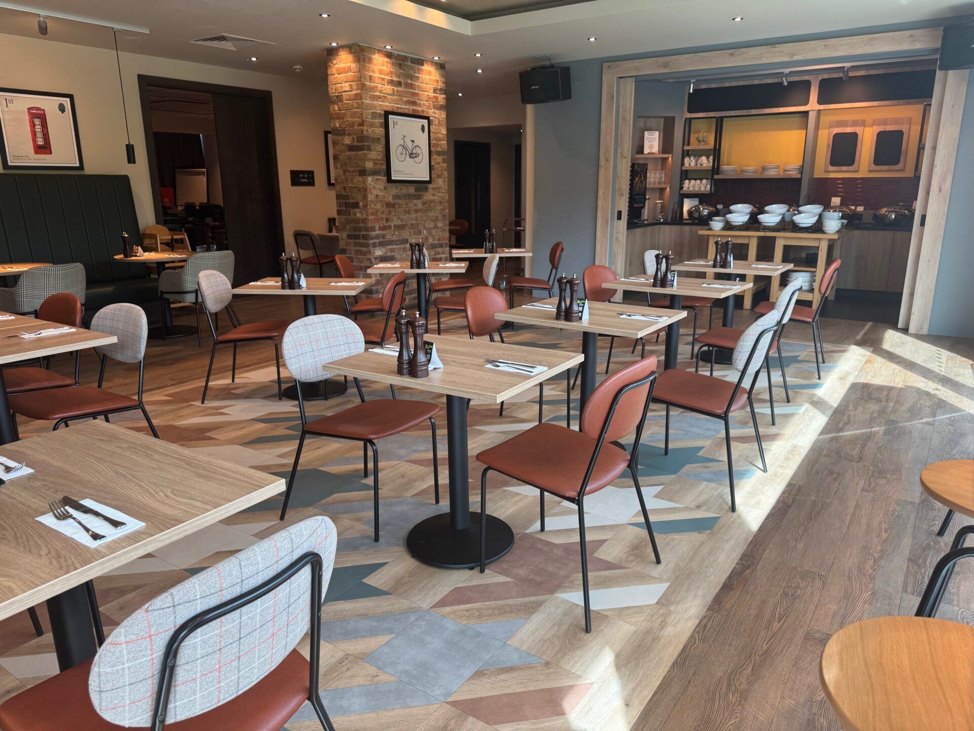 B&B Hotel Warrington B&B Hotel Warrington restaurant dining area with tables, chairs, and breakfast buffet. Interior design showcases a modern aesthetic.