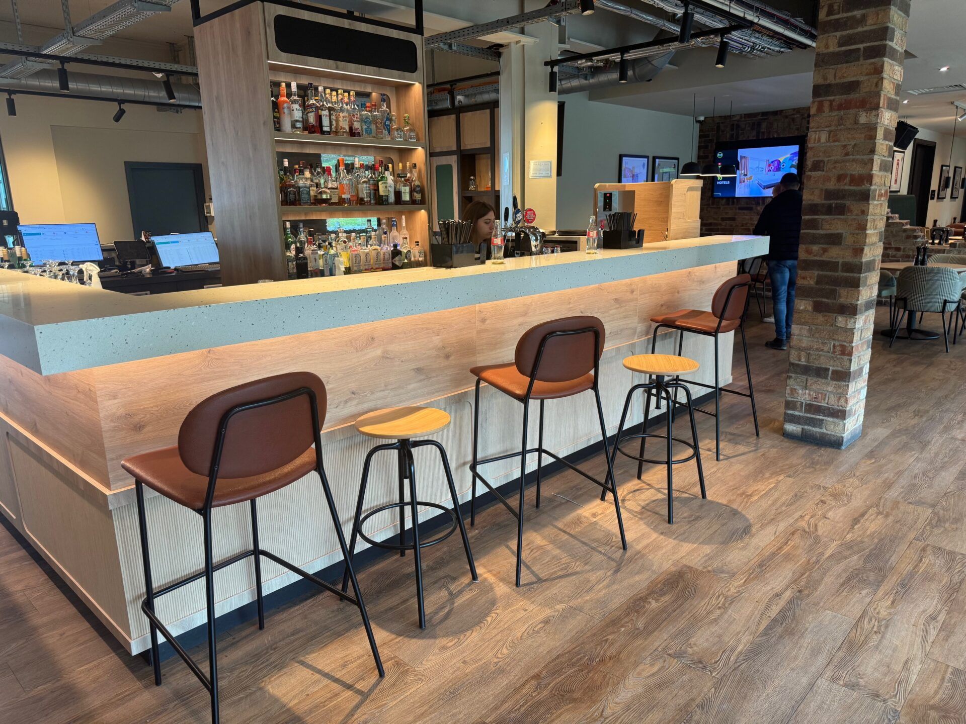 B&B Hotel Warrington B&B Hotel Warrington bar area with stools, liquor selection, and modern design for a comfortable hotel stay.